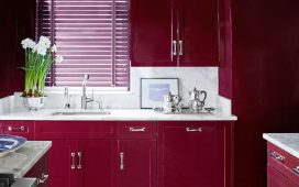 kitchen with red cherry cabinets and white marble counters and black and white geometric floor